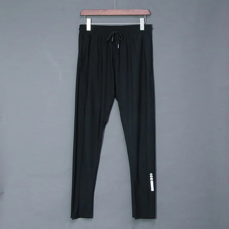 Black pants with a white logo on a gray background