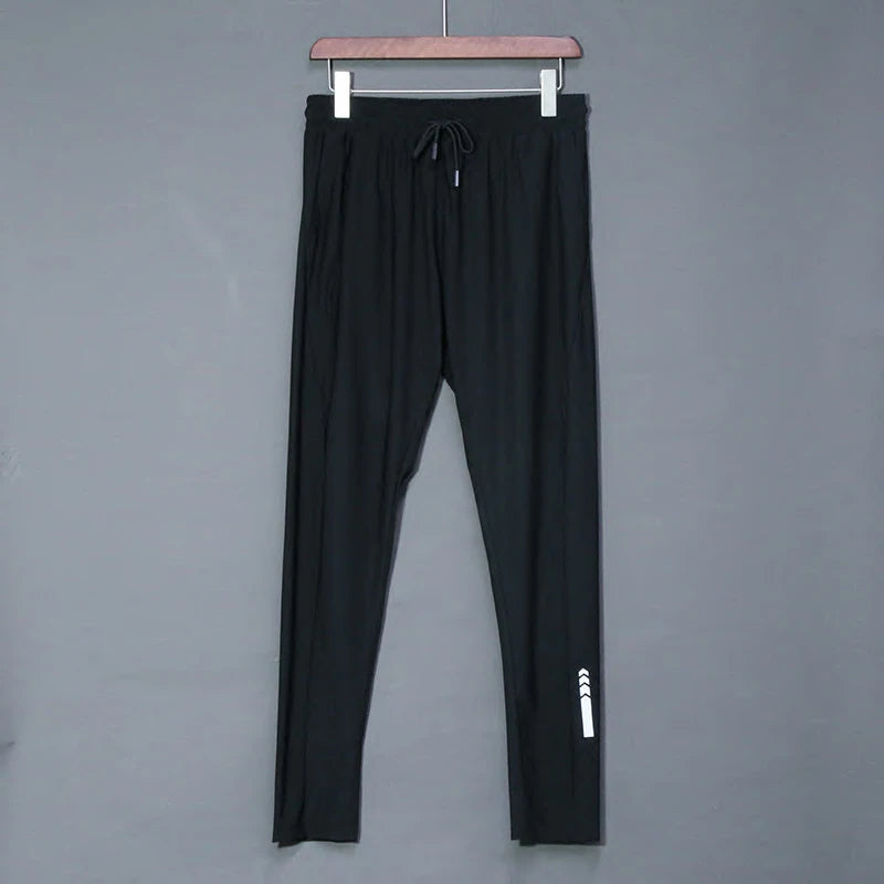 Black pants with a white logo on a gray background