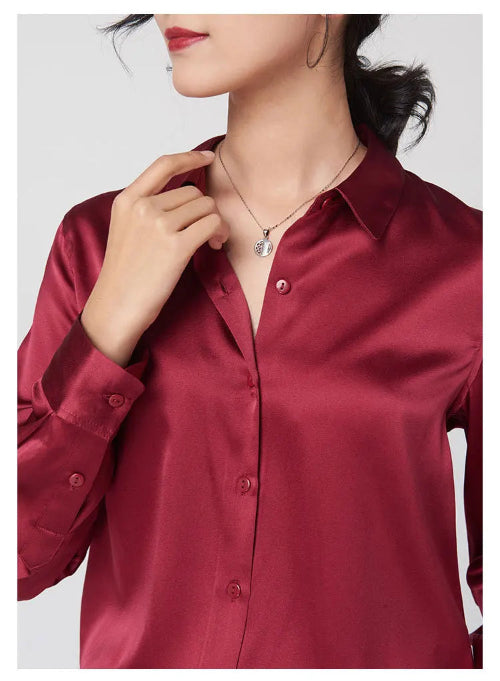 Close-up of a red silk shirt's collar and button front.