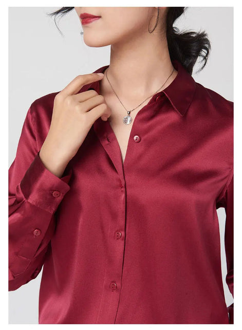 Close-up of a red silk shirt's collar and button front.