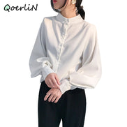 Person wearing a white blouse with a brand name 'QoerliN' in the corner.