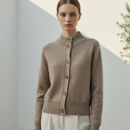 A taupe knit cardigan sweater shown on a white background, with a close-up inset of the front button and ribbed knit detail.