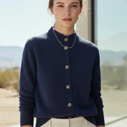 Blue cardigan with gold buttons on a white background