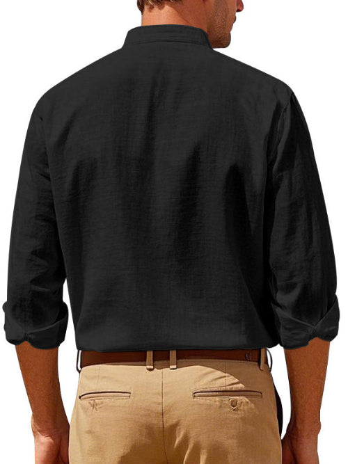 Back view of men's black linen blend stand collar shirt with rolled sleeves, tucked into khaki trousers with a brown belt