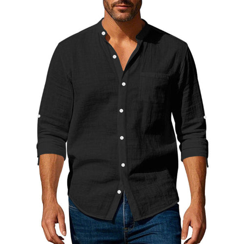 Men's black linen blend stand collar shirt with a button front, chest pocket, and rolled sleeves, worn with dark blue jeans