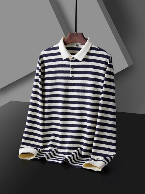 Men's navy blue and white striped long sleeve polo shirt shown from the front with a white collar, three-button placket, and white cuffs on a wooden hanger