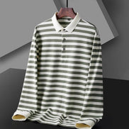 Men's green and white striped long sleeve polo shirt with a white collar and three-button placket on a wooden hanger