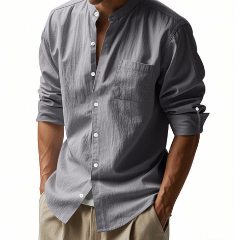 Men's gray linen blend stand collar shirt with a button front, chest pocket, and rolled tab sleeves, worn with khaki trousers