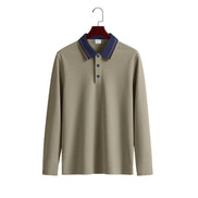 Men's taupe long sleeve polo shirt with a contrasting navy collar, fine collar stripes, and three-button placket on a wooden hanger
