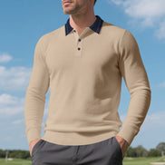 Men's khaki long sleeve polo shirt with a contrasting dark collar and three-button placket, modeled outdoors with gray trousers