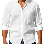 Men's white linen blend stand collar shirt with a button front, chest pocket, and rolled sleeves, worn with dark blue jeans