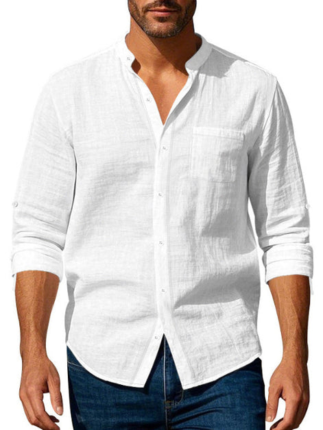 Men's white linen blend stand collar shirt with a button front, chest pocket, and rolled sleeves, worn with dark blue jeans