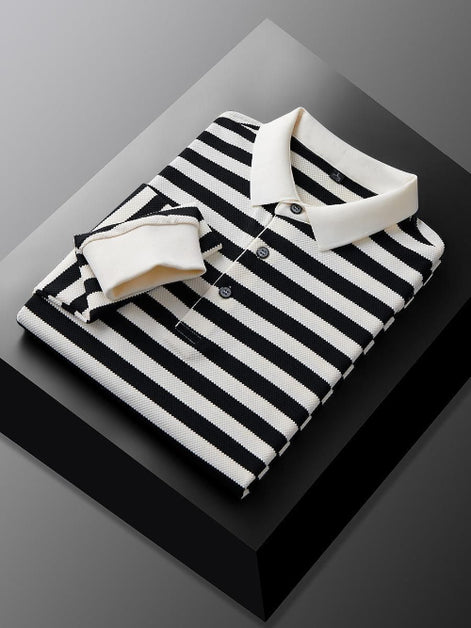 Men's black and white striped long sleeve polo shirt folded to show the white collar, three-button placket, and white cuff