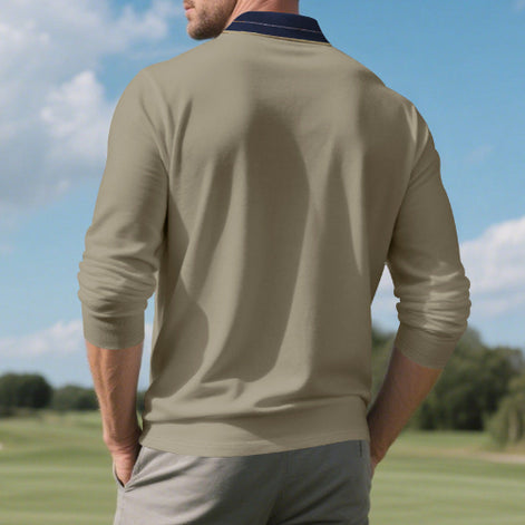 Back view of men's taupe long sleeve polo shirt with a contrasting navy collar and fine collar stripes, modeled outdoors with sleeves pushed up and gray trousers