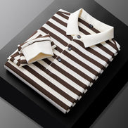 Men's brown and white striped long sleeve polo shirt folded to show the white collar, three-button placket, and white cuff