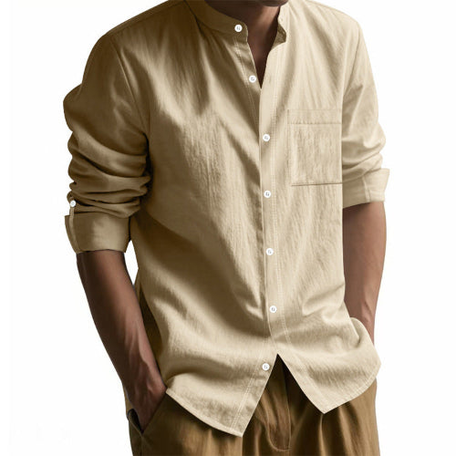 Men's khaki linen blend stand collar shirt with a button front, chest pocket, and rolled tab sleeves, worn with brown trousers