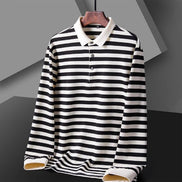 Men's black and white striped long sleeve polo shirt with a white collar and three-button placket on a wooden hanger