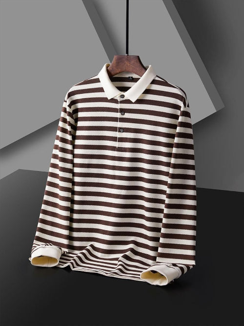Men's brown and white striped long sleeve polo shirt shown from the front with a white collar, three-button placket, and white cuffs on a wooden hanger