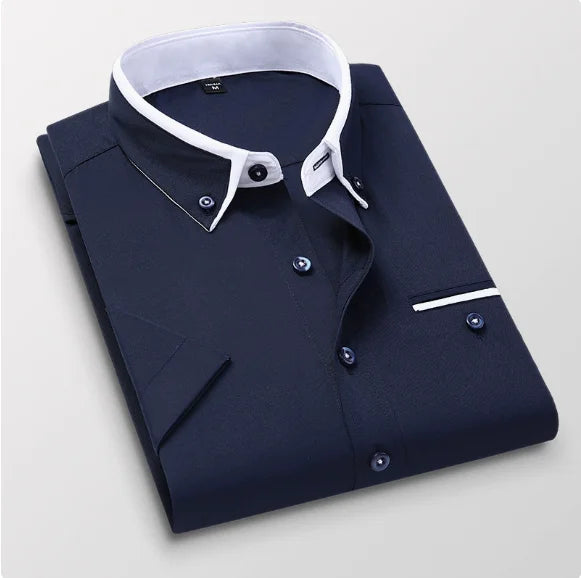 Folded navy shirt with white collar on a light gray background