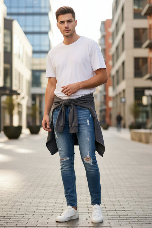 Blue distressed jeans on a white background