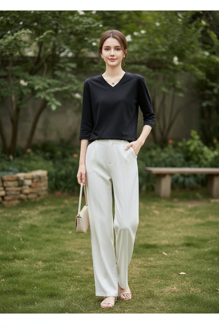 Mannequin wearing a black V-neck sweater with a neutral background