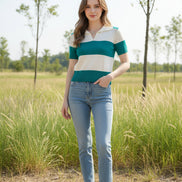 A woman wearing a short-sleeve knit polo-style top with horizontal teal and off-white stripes, seated indoors against a dark brown chair.
