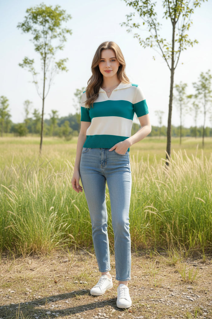 A woman wearing a short-sleeve knit polo-style top with horizontal teal and off-white stripes, seated indoors against a dark brown chair.