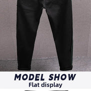Black slim-fit jeans shown flat against a textured gray background, with a white banner at the bottom reading 'MODEL SHOW Flat display'.