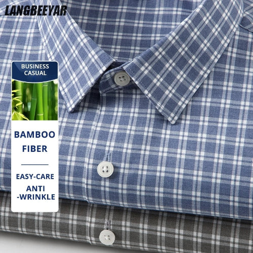 Close-up of a blue and white plaid button-down shirt with a collar and white buttons, plus a folded darker plaid shirt underneath. A vertical label reads 'BUSINESS CASUAL' and 'BAMBOO