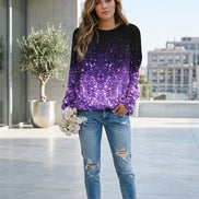 A woman wearing a long-sleeve sequined top with a black-to-purple ombré glitter effect, paired with blue jeans and holding a bouquet of white roses.