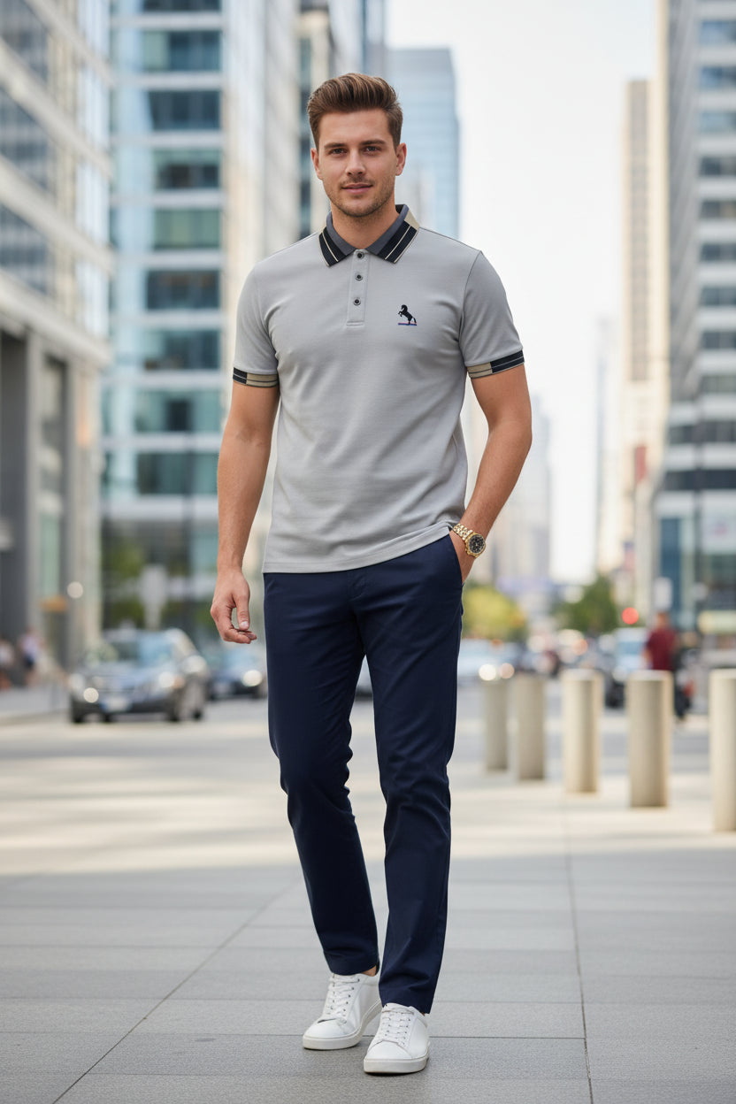 Gray polo shirt with black collar and 'MILANO ITALIA' branding, accompanied by a gold watch on a dark background.