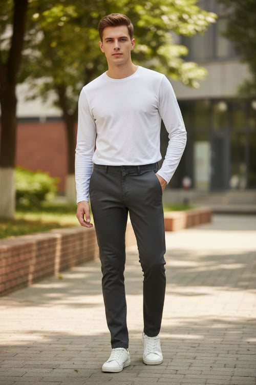 Person wearing dark gray pants and brown shoes on a gray background