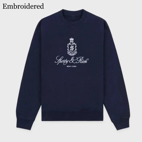 Navy blue sweatshirt with embroidered logo and text on a light gray background