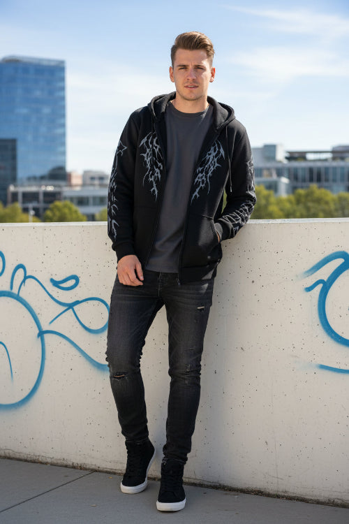 Black hoodie with tribal wing designs on sleeves against a white background