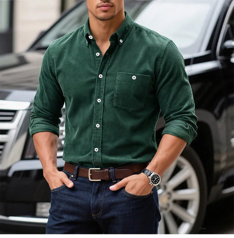 A man wearing a dark green long-sleeve button-down shirt with a chest pocket, 