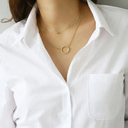 Close-up of the collar and chest pocket of a white button-down shirt.