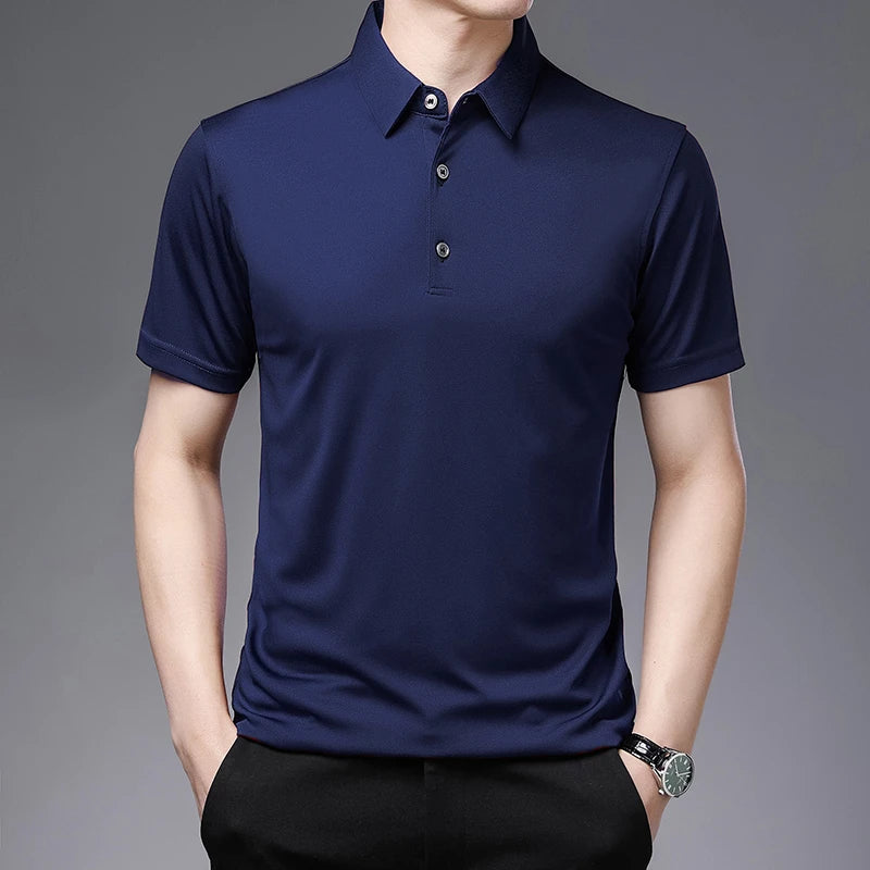 Navy blue polo shirt worn by a person on a gray background