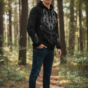 Black hoodie with a wolf design on the back against a white background