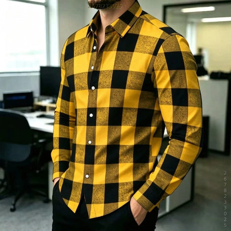 A man wearing a long-sleeve button-up shirt with a bold yellow and black buffalo check pattern, standing in an office environment.