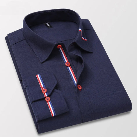 Folded navy blue shirt with red and white striped accents on a light gray background