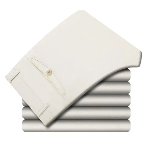 Stack of folded white pants on a white background