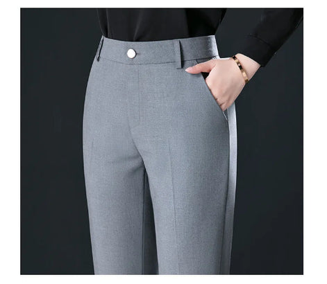 Gray pants worn with a black shirt on a dark background