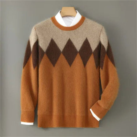 A men's long-sleeve knit sweater with a classic argyle pattern in beige, brown, and rust orange, styled over a white collared shirt on a wooden hanger against a solid gray background.