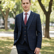 Navy checkered suit on a mannequin with a pink tie against a beige curtain background