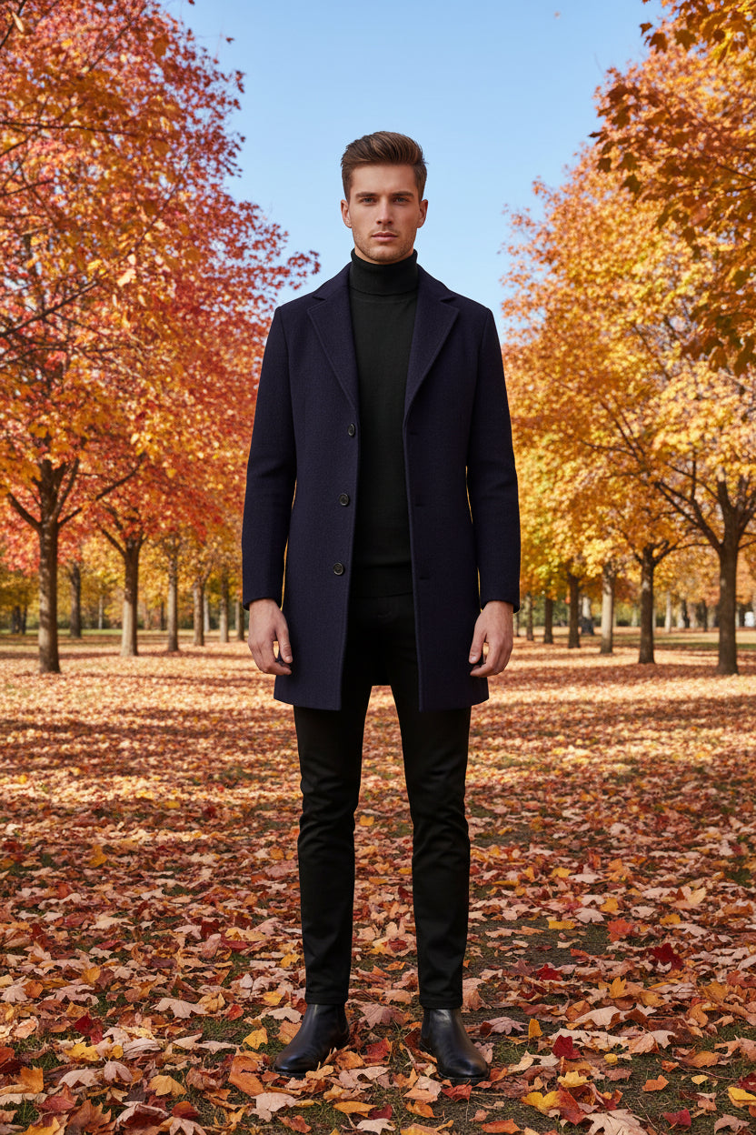 Person wearing a Navy Bluecoat over a black turtleneck and pants on a white background