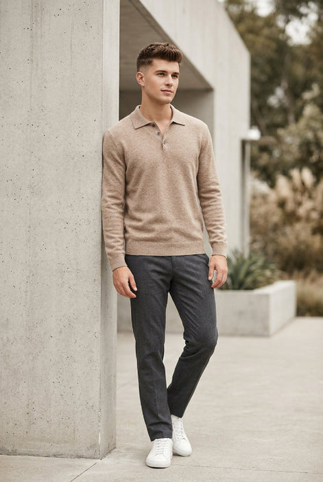 Beige sweater on a hanger against a gray background