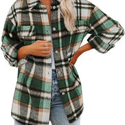 Woman wearing a green and cream plaid shirt with a white top and jeans, against a white background.
