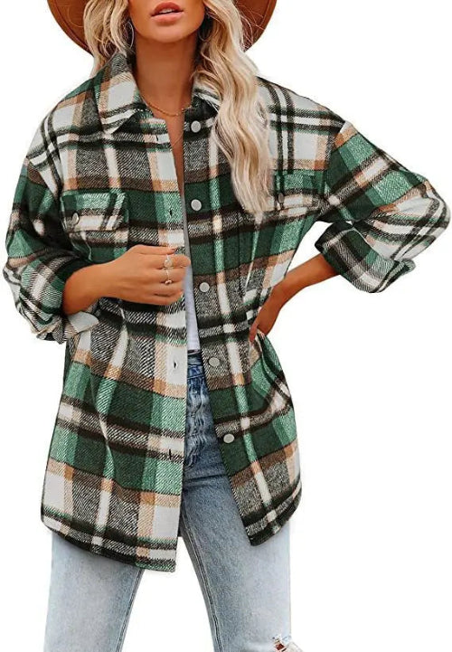 Woman wearing a green and cream plaid shirt with a white top and jeans, against a white background.