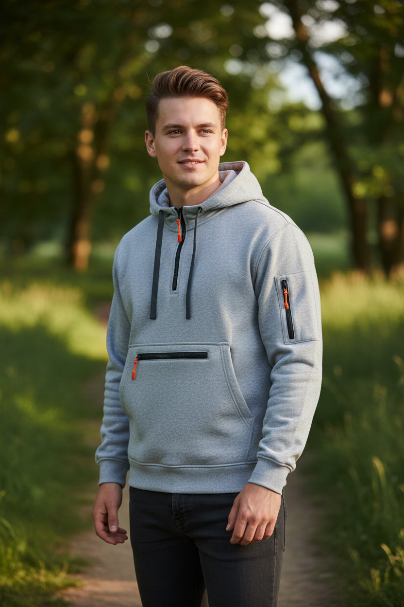 A light gray heather pullover hoodie with a half-zip neckline, a front kangaroo pocket, and zippered pockets on the chest and sleeve, shown against a plain off-white background.