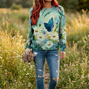 A woman wearing a long-sleeve crewneck sweatshirt with a vibrant 3D floral and butterfly print. 